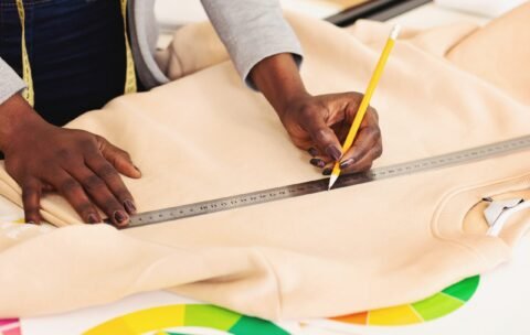 person-is-shown-image-measuring-piece-cloth-using-ruler-focusing-intently-min